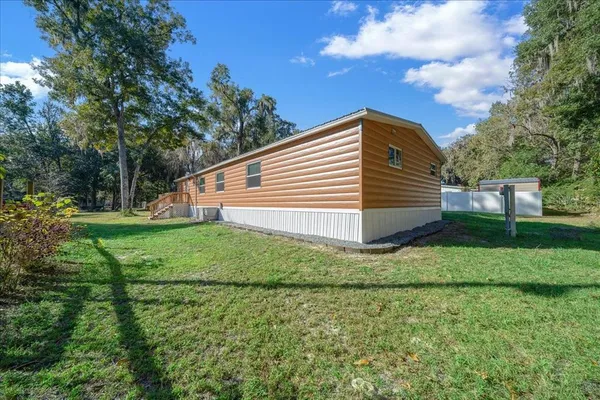a view of a backyard with white house