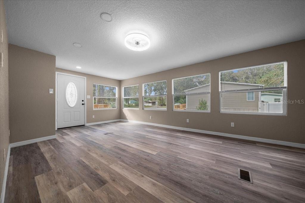 339 Southwest 83rd Street Ocala, FL 34476 - Photo 8 of 34 a view of an empty room with a window and wooden floor