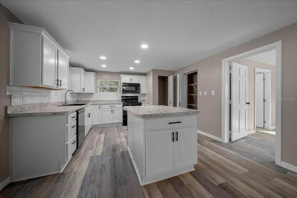 a kitchen with stainless steel appliances granite countertop a stove and a refrigerator