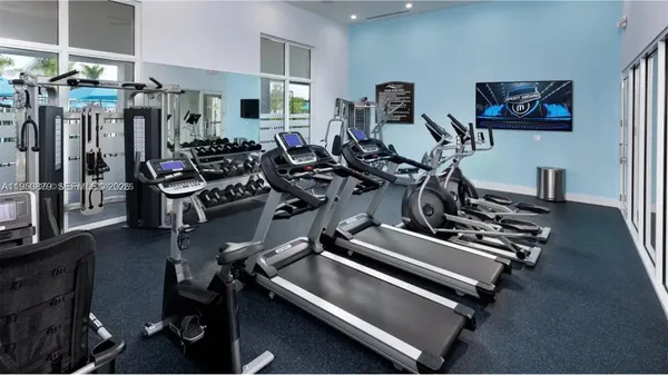 a room with gym equipment and a large window
