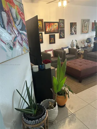 a living room with furniture flowerpot and wooden floor