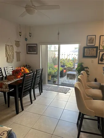 a outdoor dining space with furniture and a floor to ceiling window