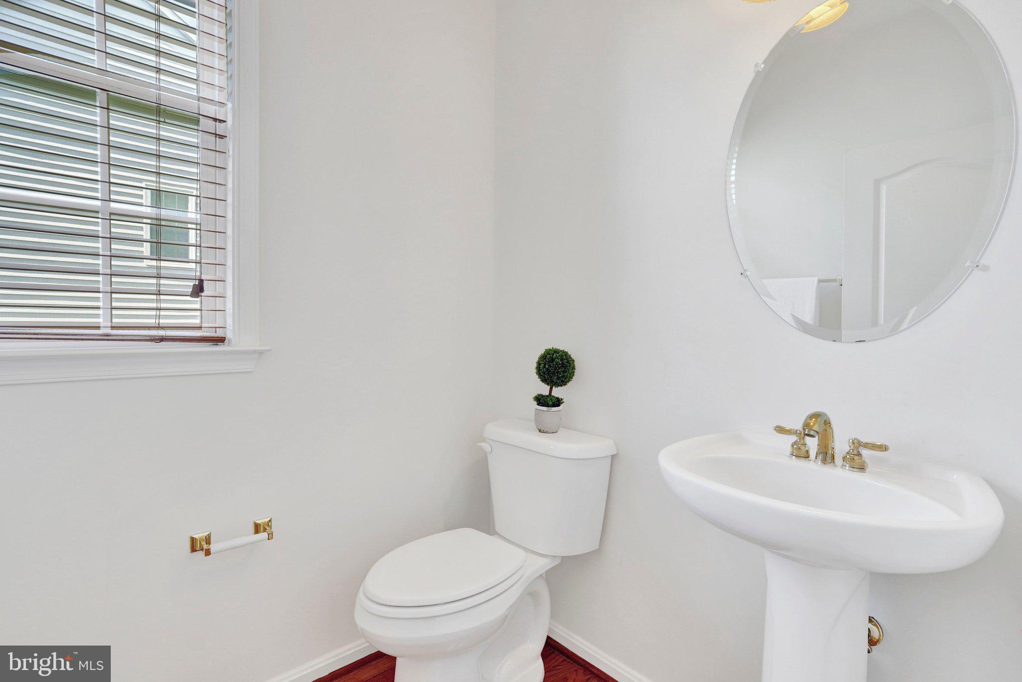 6247 Rolling Spring Court Springfield, VA 22152 - Photo 11 of 52 a bathroom with a toilet sink and mirror