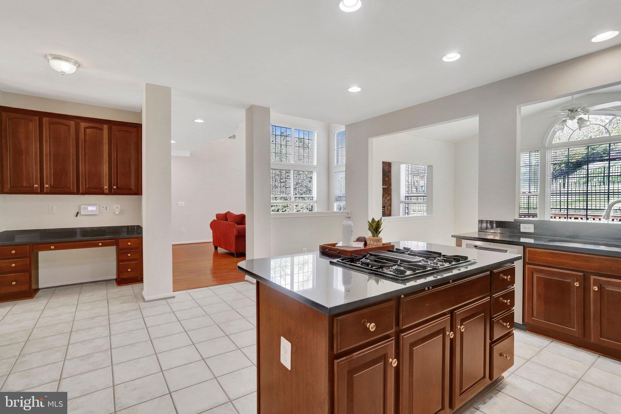 6247 Rolling Spring Court Springfield, VA 22152 - Photo 21 of 52 a kitchen with stainless steel appliances a stove a sink and a microwave