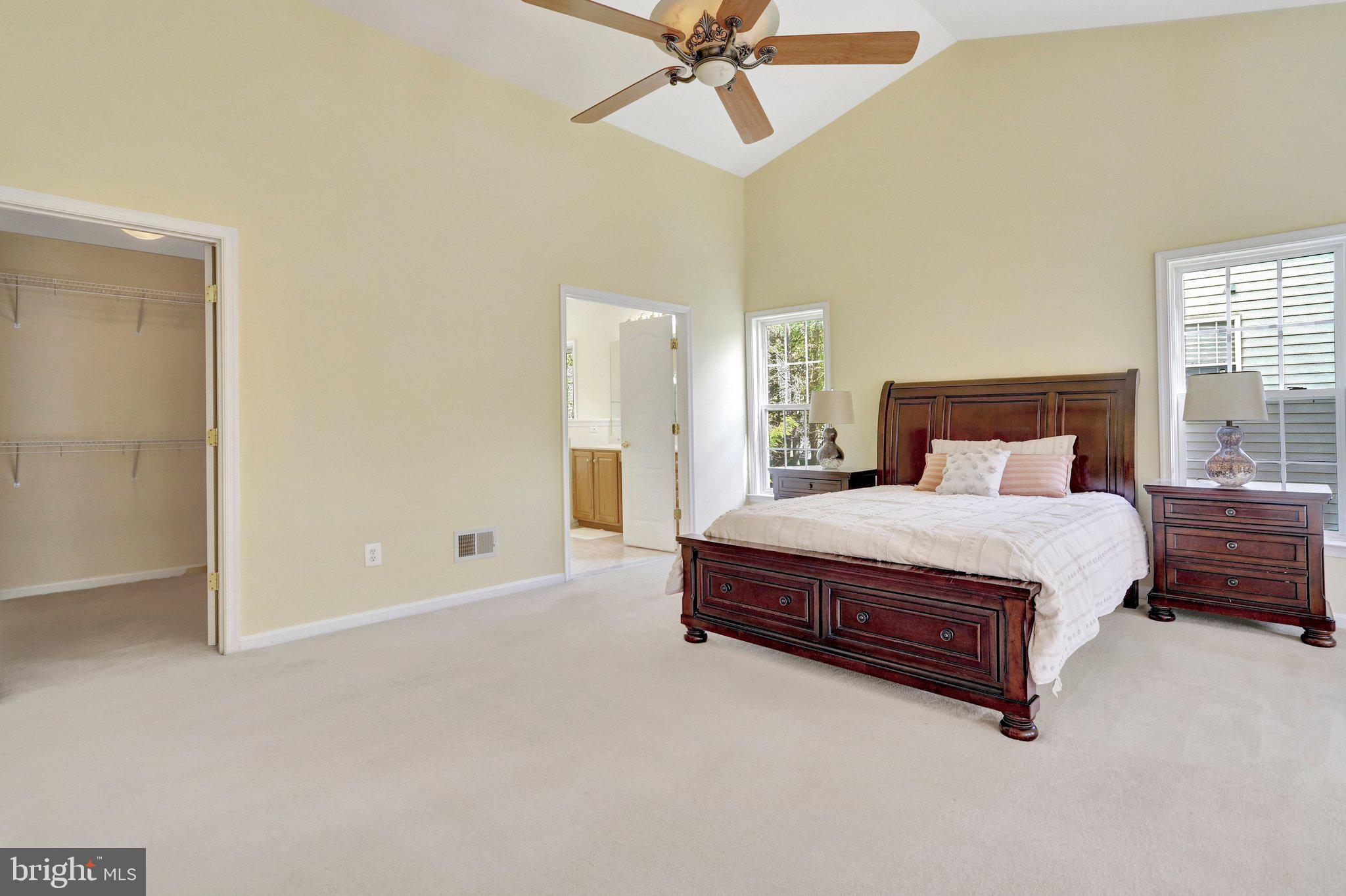6247 Rolling Spring Court Springfield, VA 22152 - Photo 25 of 52 a bedroom with a large bed and a chandelier