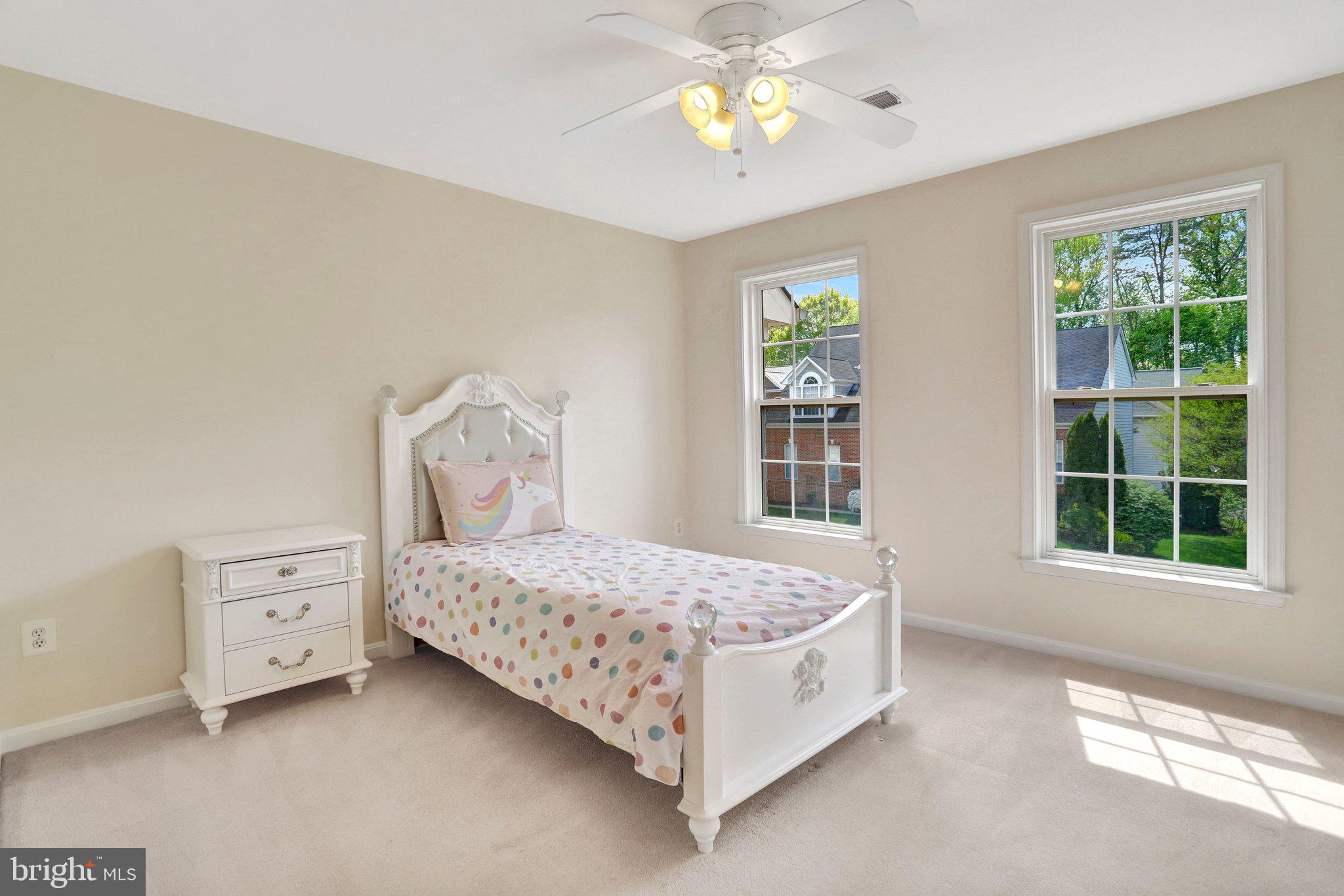 6247 Rolling Spring Court Springfield, VA 22152 - Photo 29 of 52 a bed sitting in a bedroom next to a window