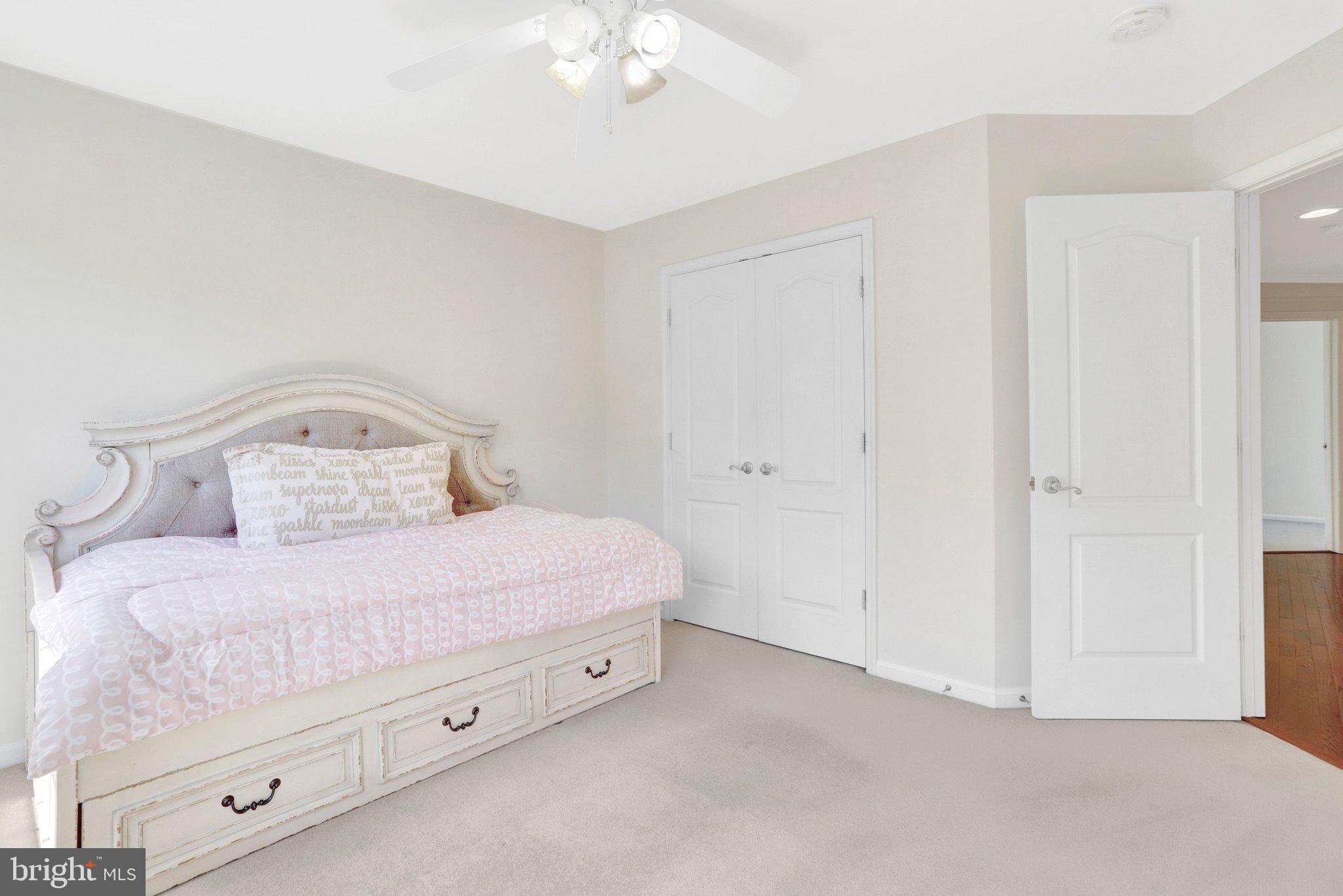 6247 Rolling Spring Court Springfield, VA 22152 - Photo 32 of 52 a bedroom with a bed and a chandelier