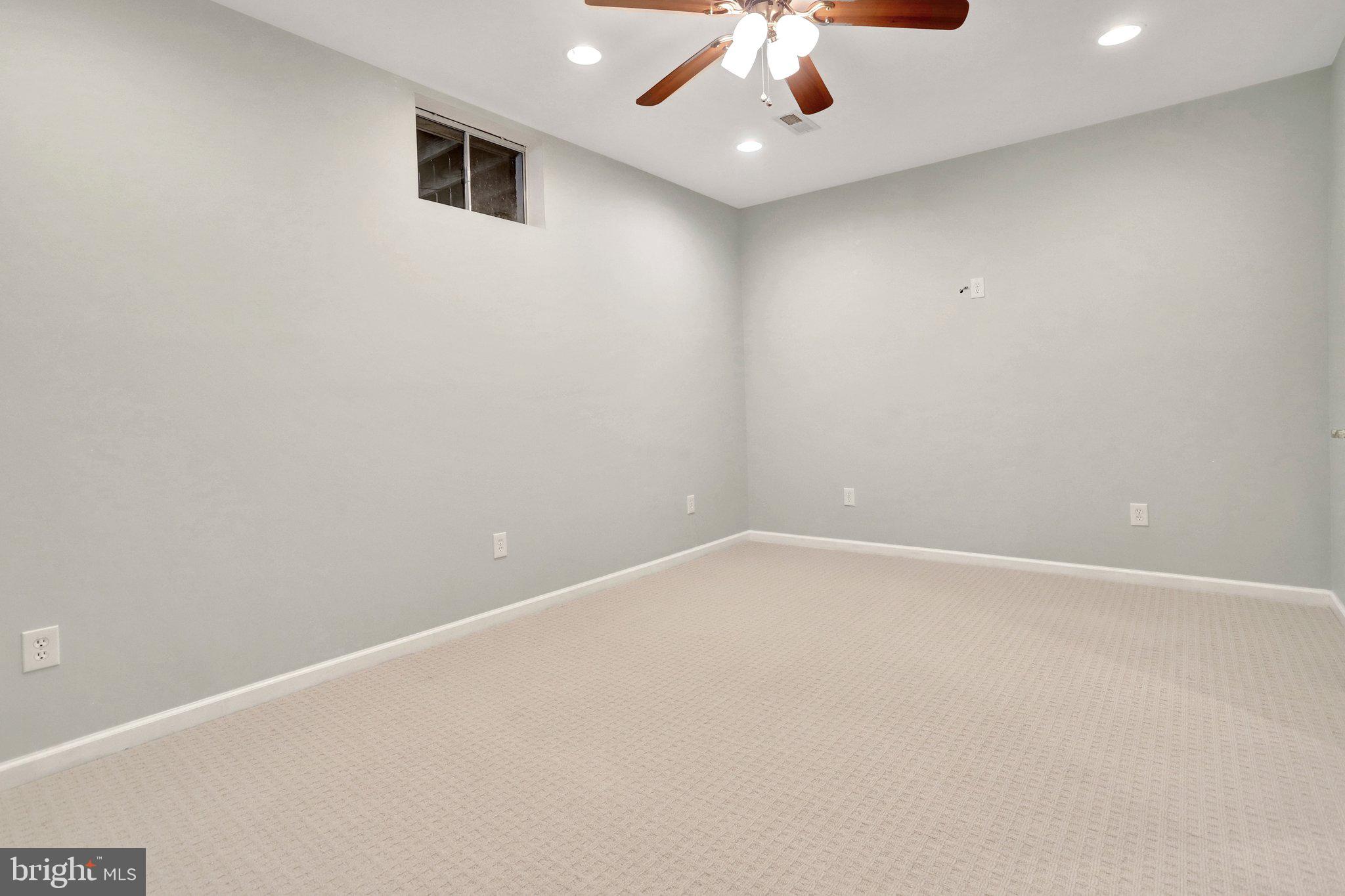6247 Rolling Spring Court Springfield, VA 22152 - Photo 45 of 52 an empty room with a ceiling fan and window