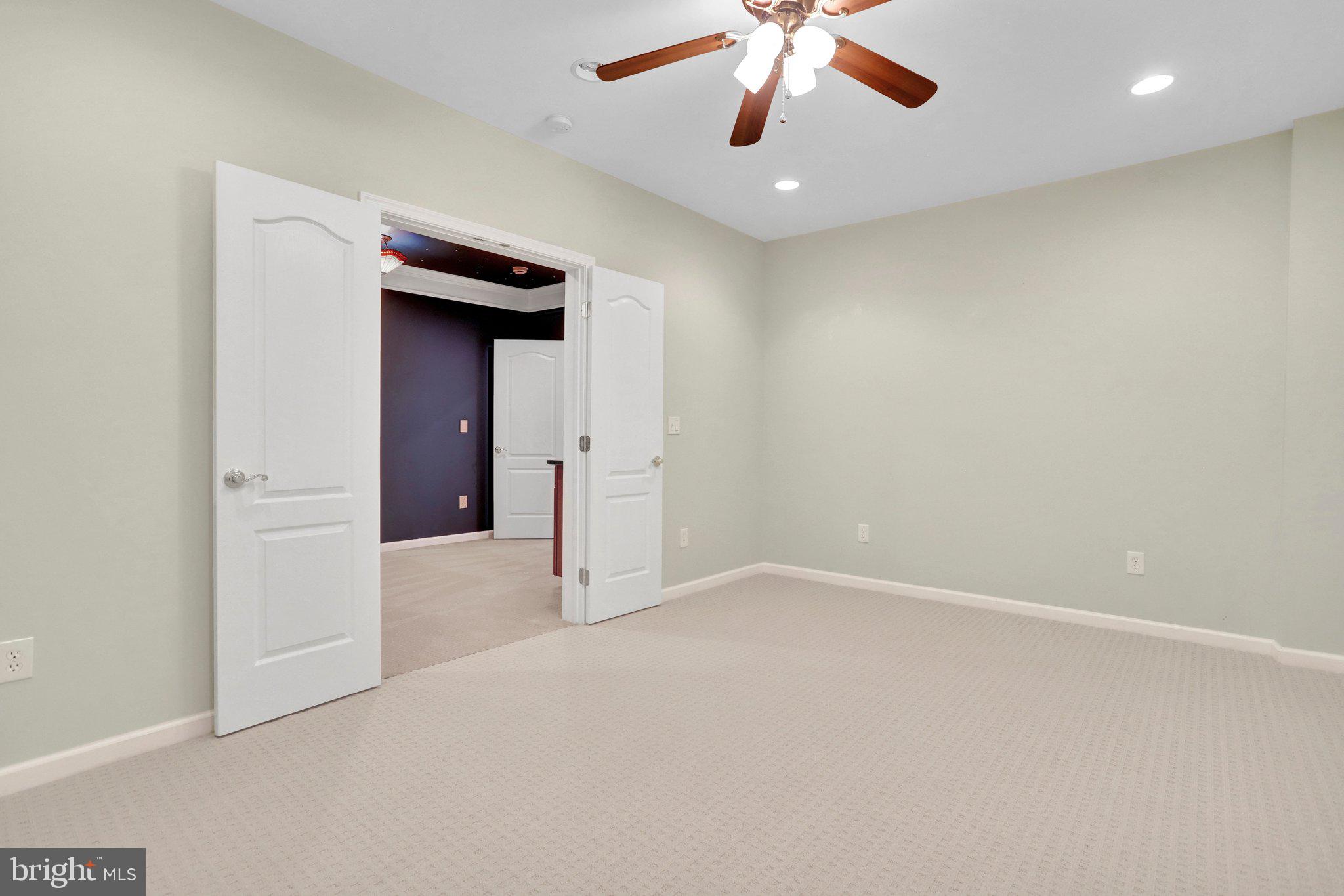 6247 Rolling Spring Court Springfield, VA 22152 - Photo 46 of 52 an empty room with a ceiling fan and carpet