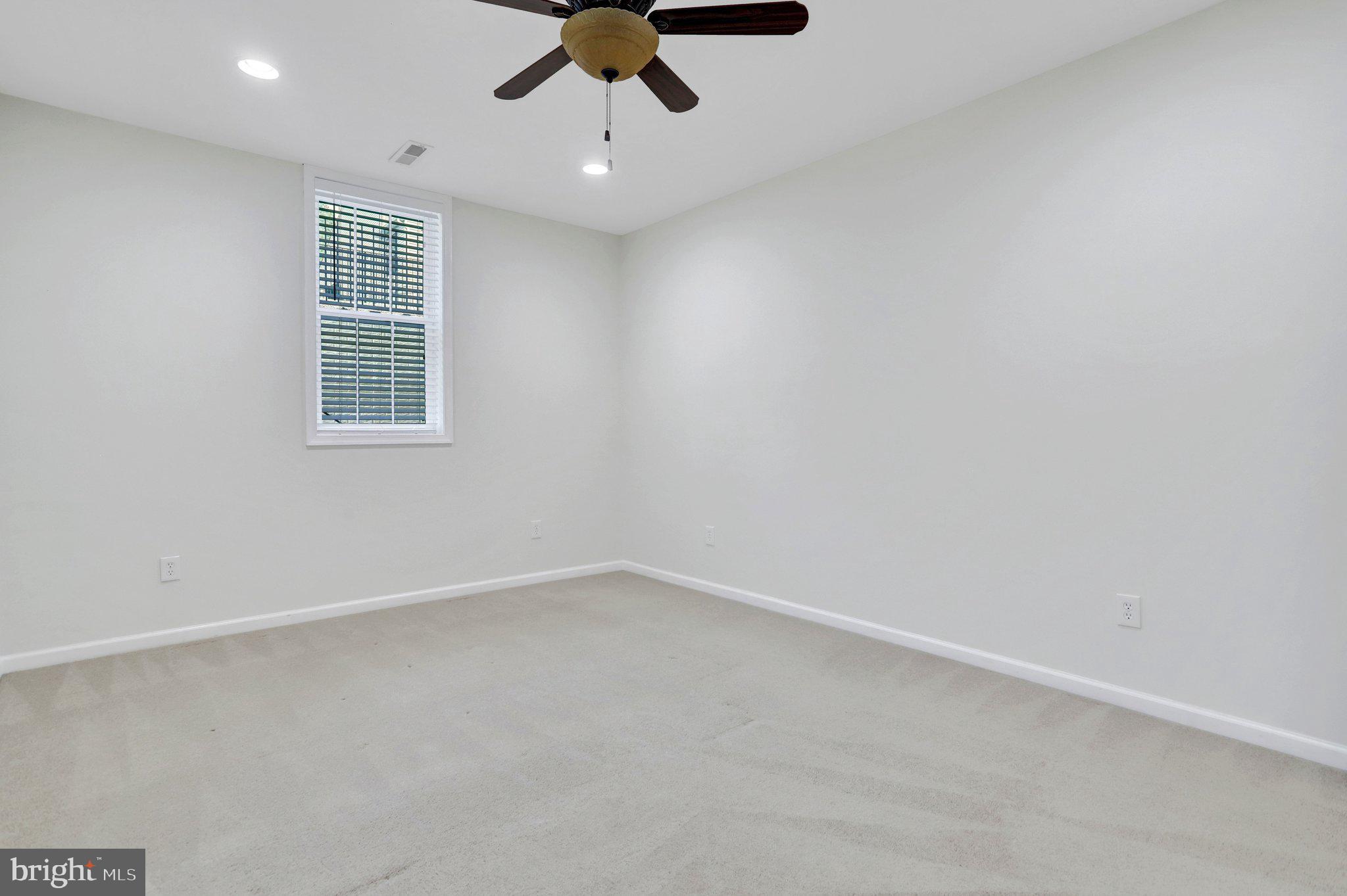 6247 Rolling Spring Court Springfield, VA 22152 - Photo 48 of 52 an empty room with a window and a fan