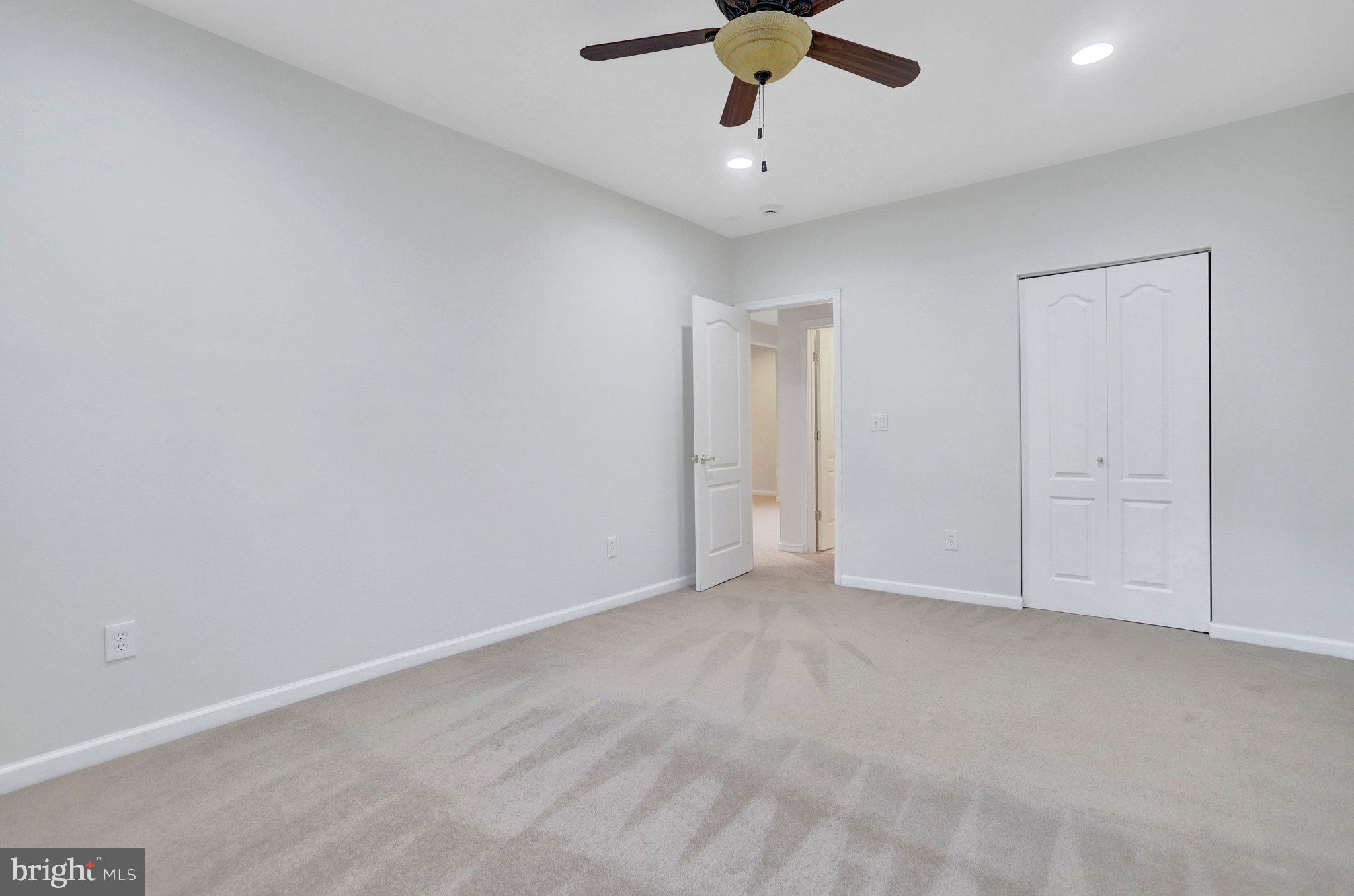6247 Rolling Spring Court Springfield, VA 22152 - Photo 49 of 52 an empty room with a ceiling fan and carpet