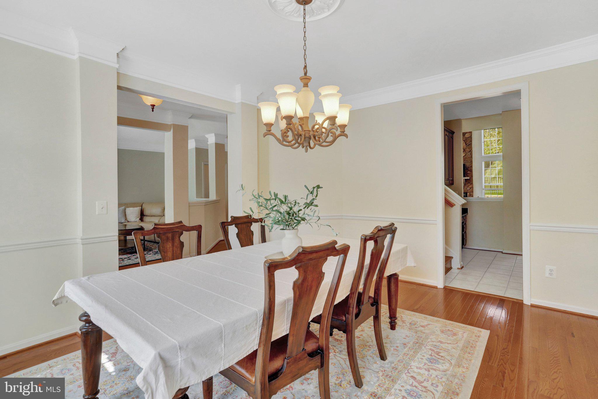 6247 Rolling Spring Court Springfield, VA 22152 - Photo 8 of 52 a view of a dining room with furniture and wooden floor
