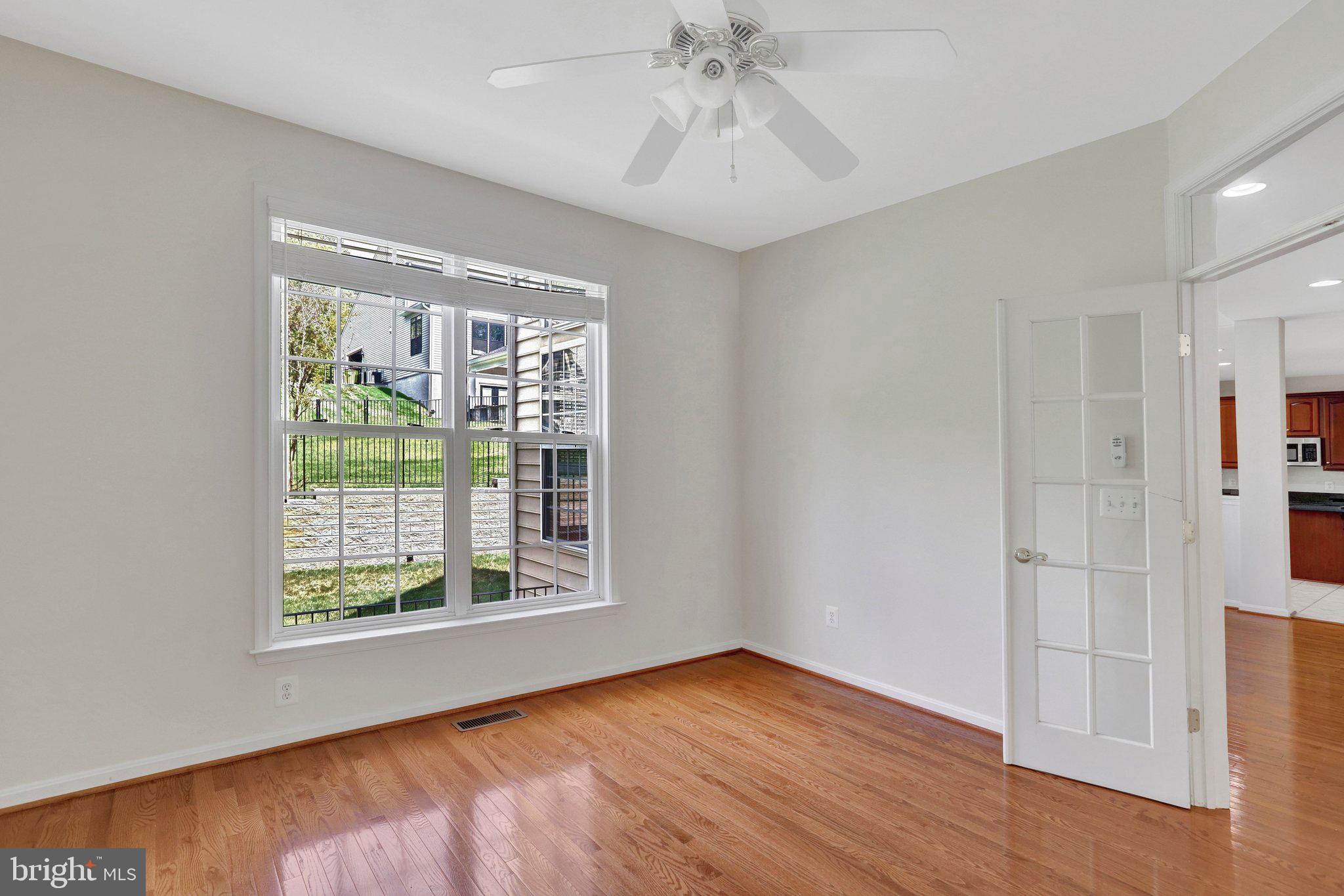 6247 Rolling Spring Court Springfield, VA 22152 - Photo 10 of 52 a view of an empty room with wooden floor and a window