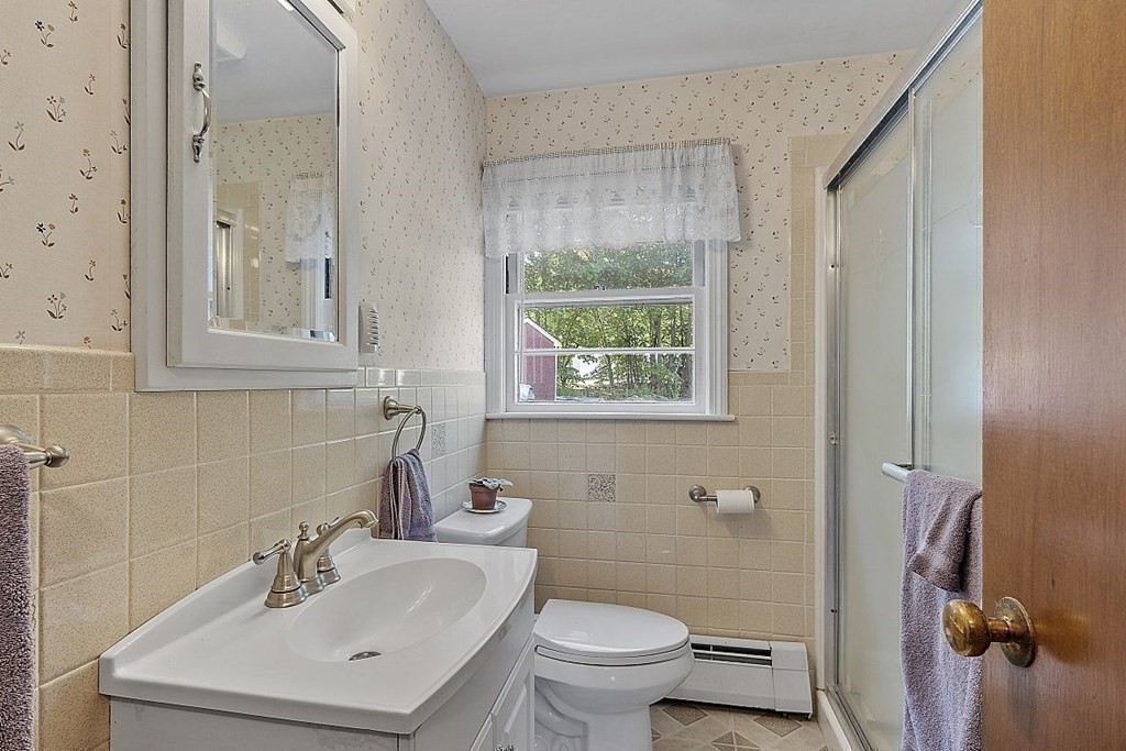 338 Donohue Road Dracut, MA 01826 - Photo 15 of 38 a bathroom with a sink toilet and shower