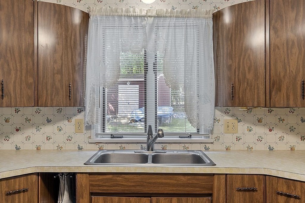 338 Donohue Road Dracut, MA 01826 - Photo 17 of 38 a view of a kitchen with a sink and wooden floor