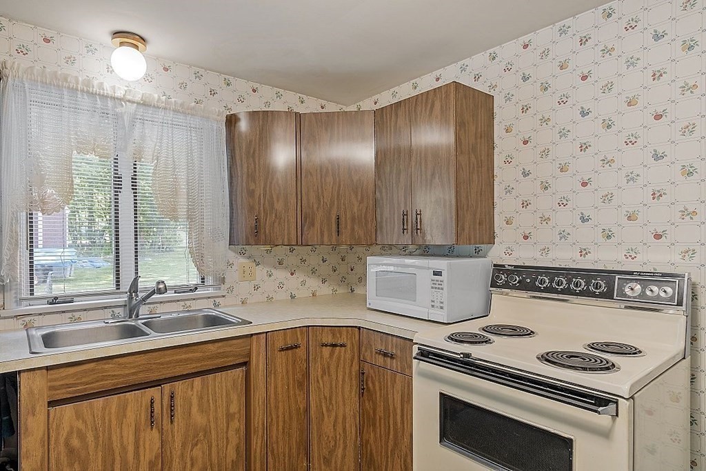 338 Donohue Road Dracut, MA 01826 - Photo 19 of 38 a kitchen with a stove and a sink