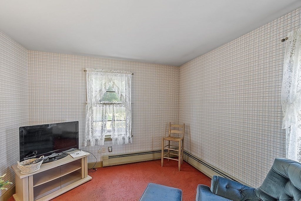 338 Donohue Road Dracut, MA 01826 - Photo 25 of 38 a room with furniture and flat screen tv