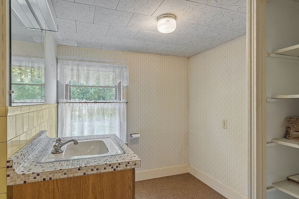 338 Donohue Road Dracut, MA 01826 - Photo 32 of 38 a bathroom with a granite countertop sink a toilet and a shower