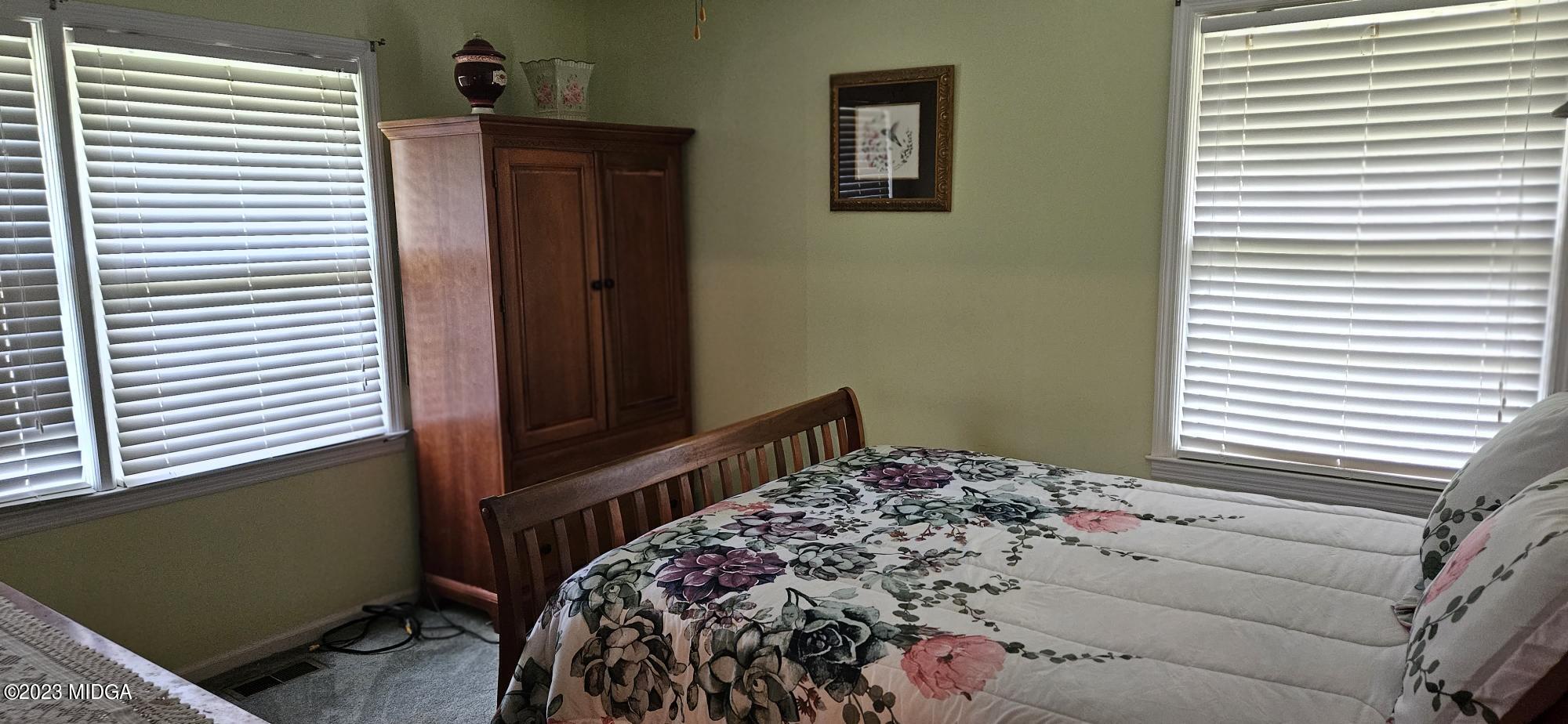 196 Candler Road Gray, GA 31032 - Photo 11 of 16 a bedroom with a bed and a window