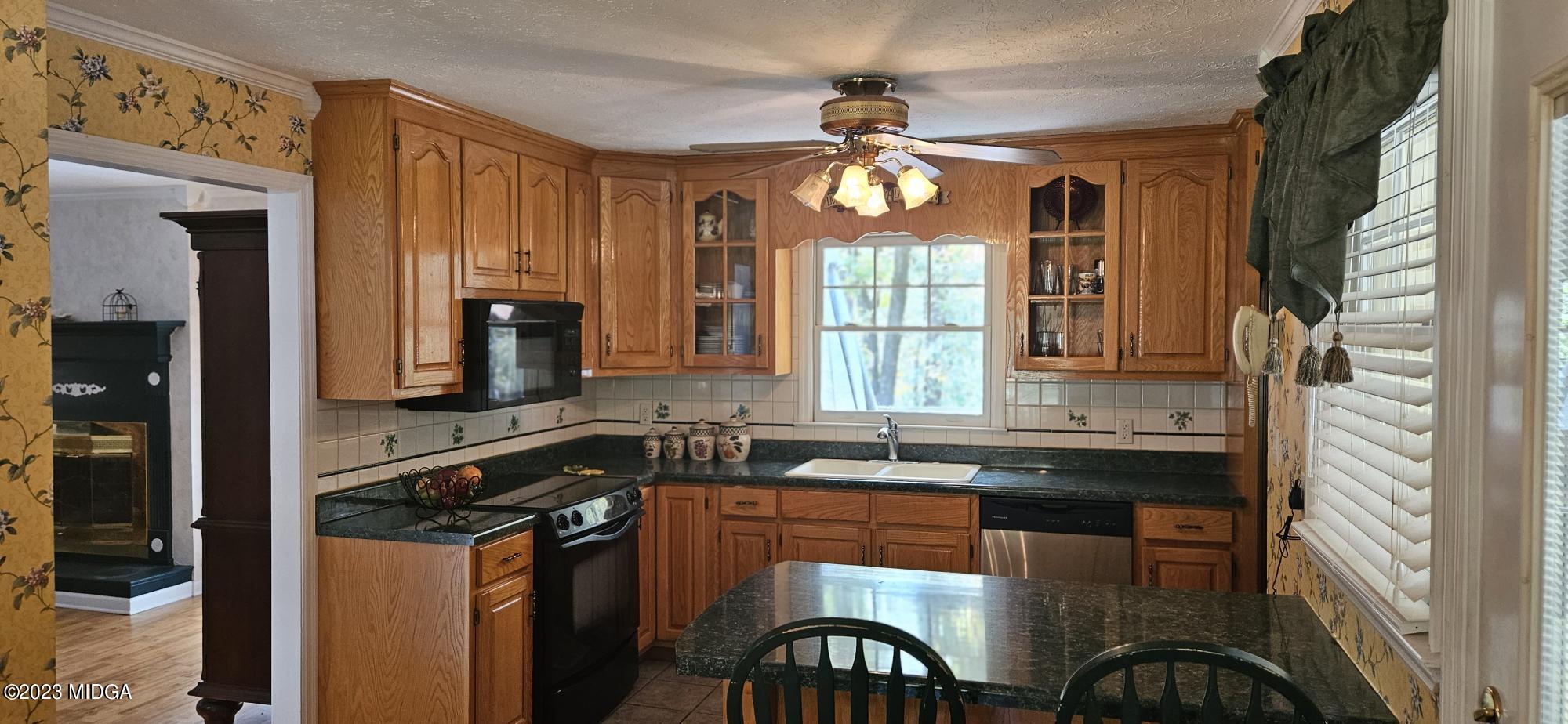 196 Candler Road Gray, GA 31032 - Photo 5 of 16 a kitchen with stainless steel appliances granite countertop a sink stove and refrigerator