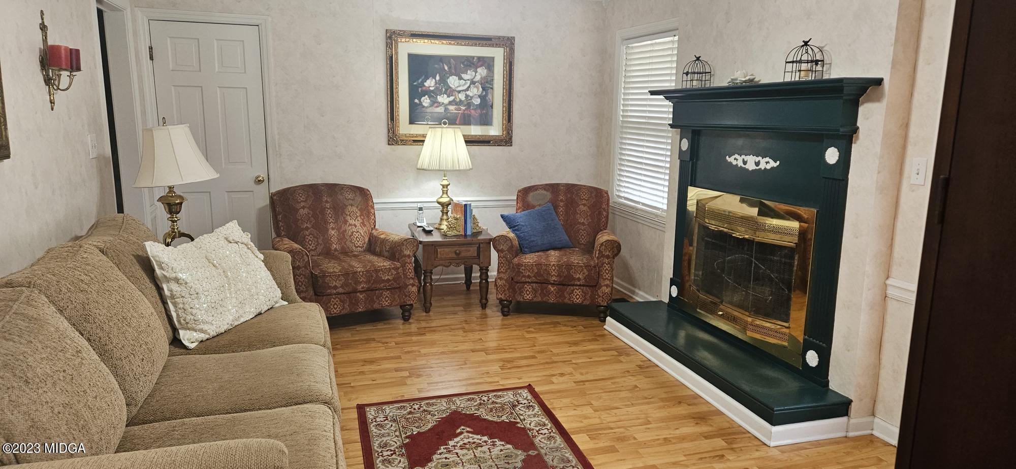 196 Candler Road Gray, GA 31032 - Photo 7 of 16 a living room with furniture and a fireplace