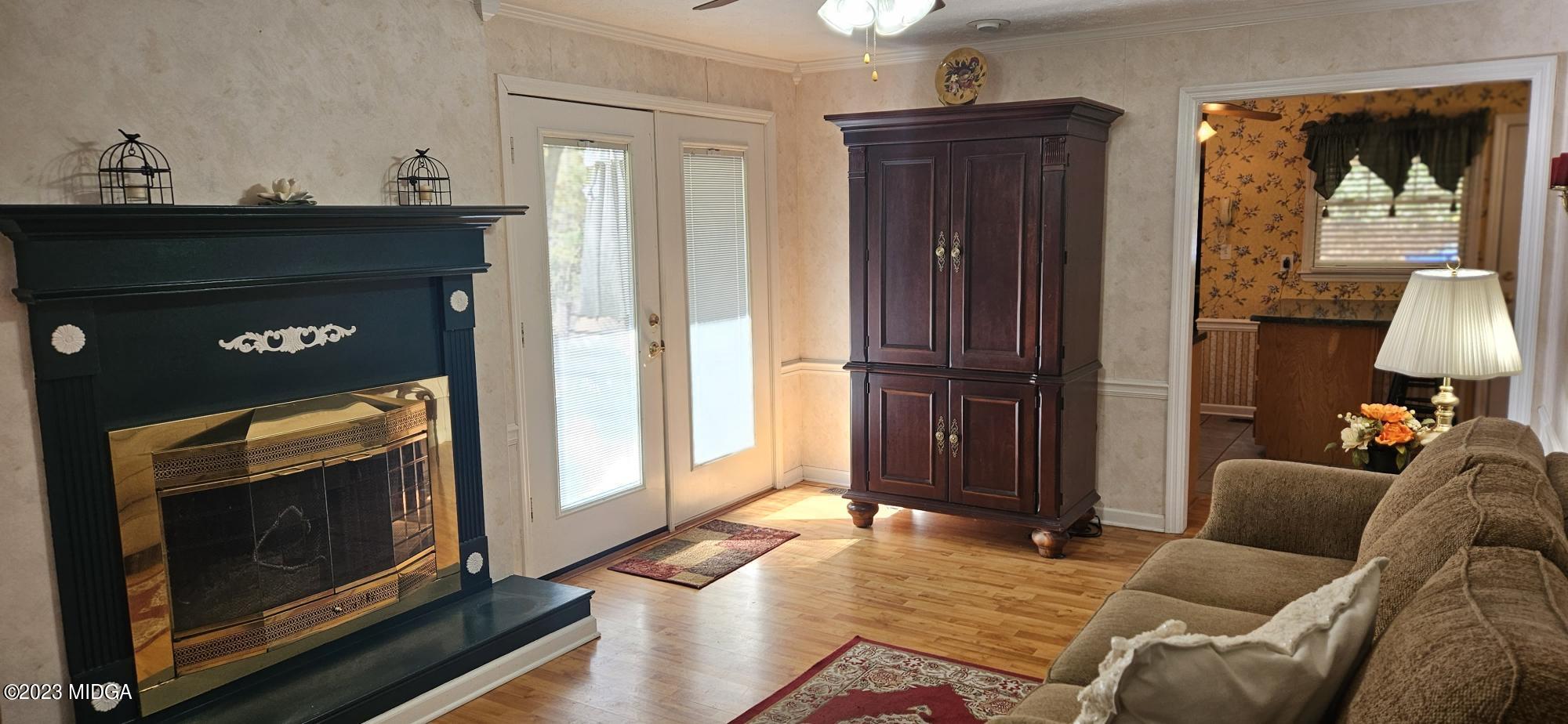 196 Candler Road Gray, GA 31032 - Photo 8 of 16 a living room with furniture and a fireplace