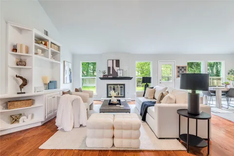 a living room with furniture a fireplace and a window