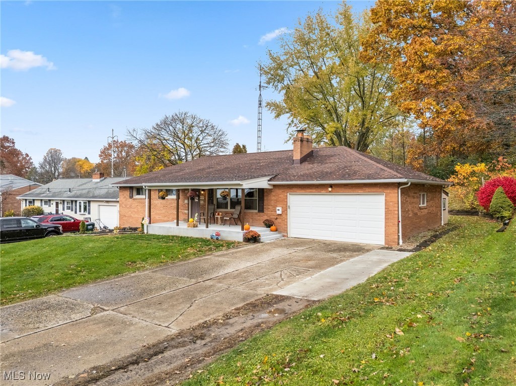 4727 15th Street Northwest Canton, OH 44708 - Photo 3 of 37 Single story home with a front yard, brick siding, covered porch, a chimney, and driveway
