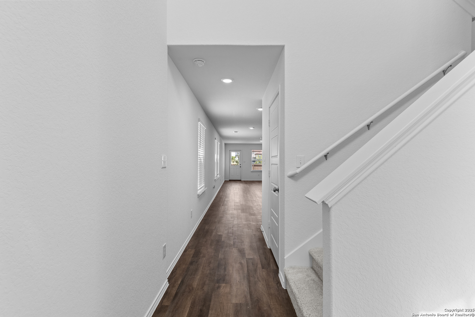 416 Raven Row Marion, TX 78124 - Photo 2 of 29 a view of a hallway with wooden floor and staircase