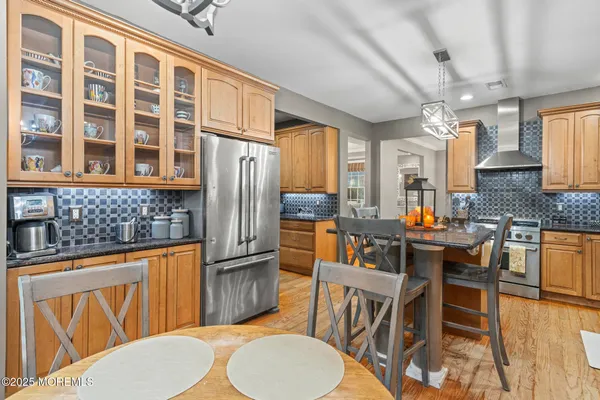 a kitchen with a table chairs stove and refrigerator
