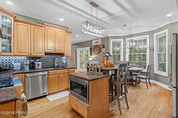 a open kitchen with stainless steel appliances granite countertop a stove and cabinets