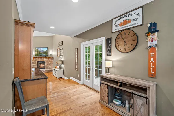 a living room with furniture a clock and a window