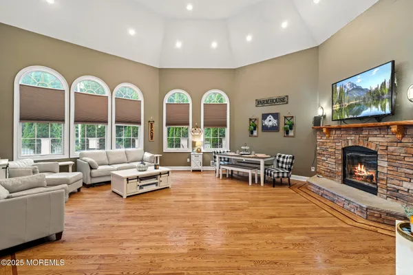 a living room with furniture fireplace and flat screen tv
