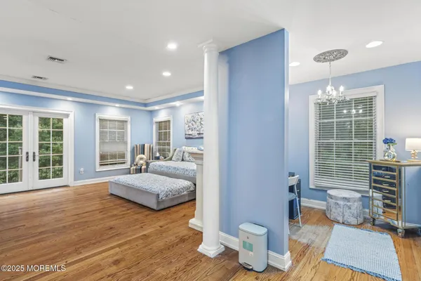 a bedroom with furniture and a large window