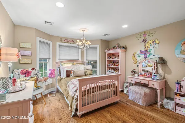 a bedroom with furniture and a chandelier