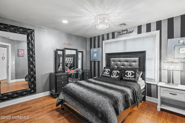 a bedroom with a bed and a mirror