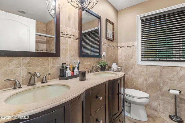 a bathroom with a toilet sink and mirror