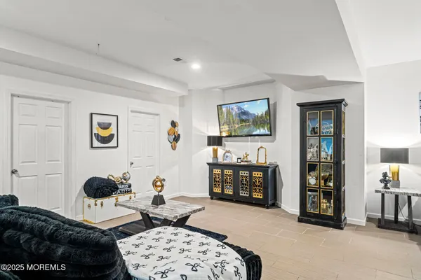 a bedroom with furniture a baby crib and dresser