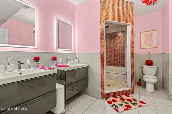a bathroom with a sink mirror and toilet