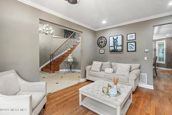 a living room with furniture and wooden floor