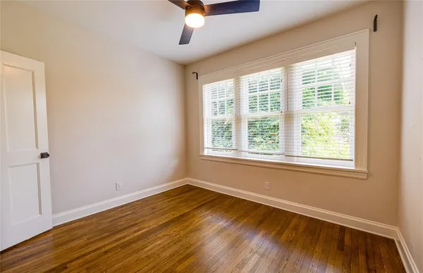 a view of a room with wooden floor and a window