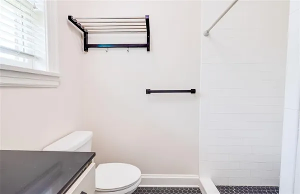 a white toilet sitting next to a bathroom sink