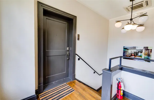 a view of entryway and hall with wooden floor