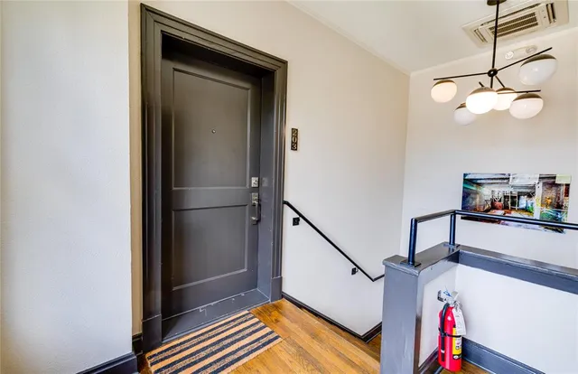 a view of entryway and hall with wooden floor