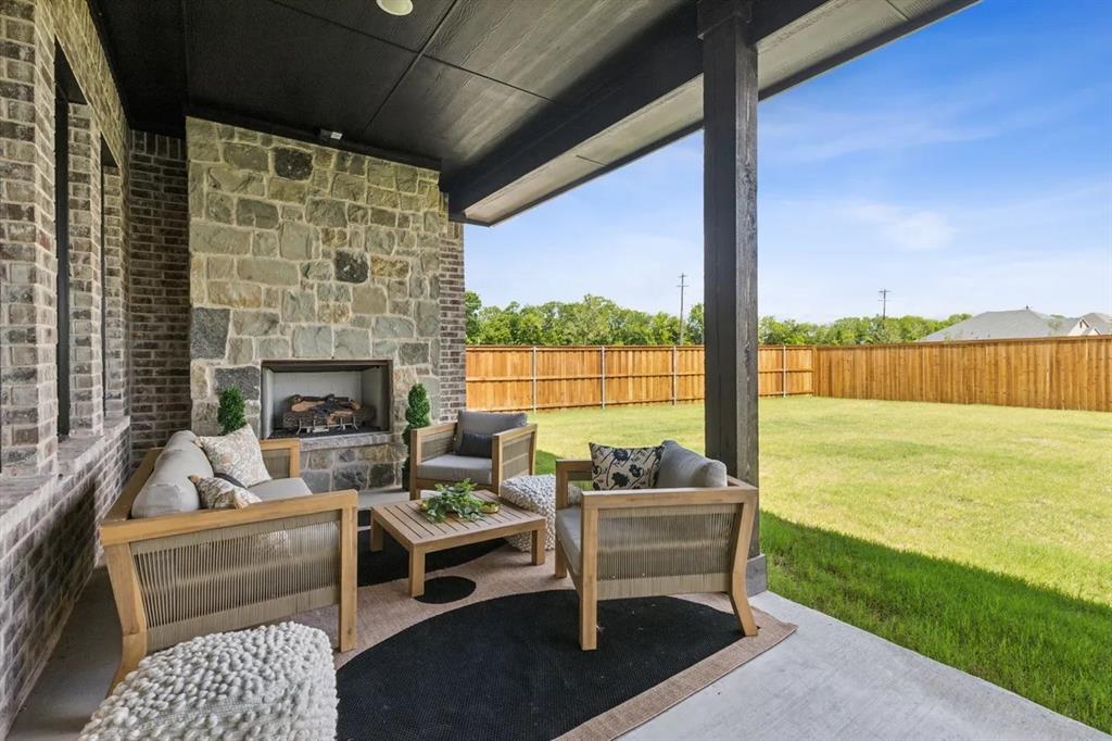1310 Benjamin Trail Van Alstyne, TX 75495 - Photo 27 of 27 Fenced backyard with a patio area and an outdoor living space with a fireplace