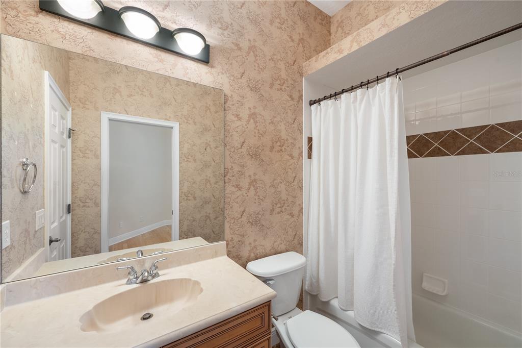 8119 Vía Rosa Orlando, FL 32836 - Photo 30 of 62 a bathroom with a sink a toilet and shower curtain