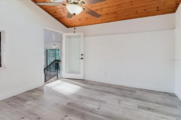 a view of house with a tree and wooden fence