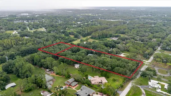 a view of a big yard with large trees and a big yard