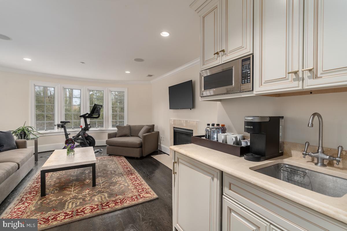 7803 Radnor Road Bethesda, MD 20817 - Photo 22 of 51 Sitting room with fireplace and mini kitchen