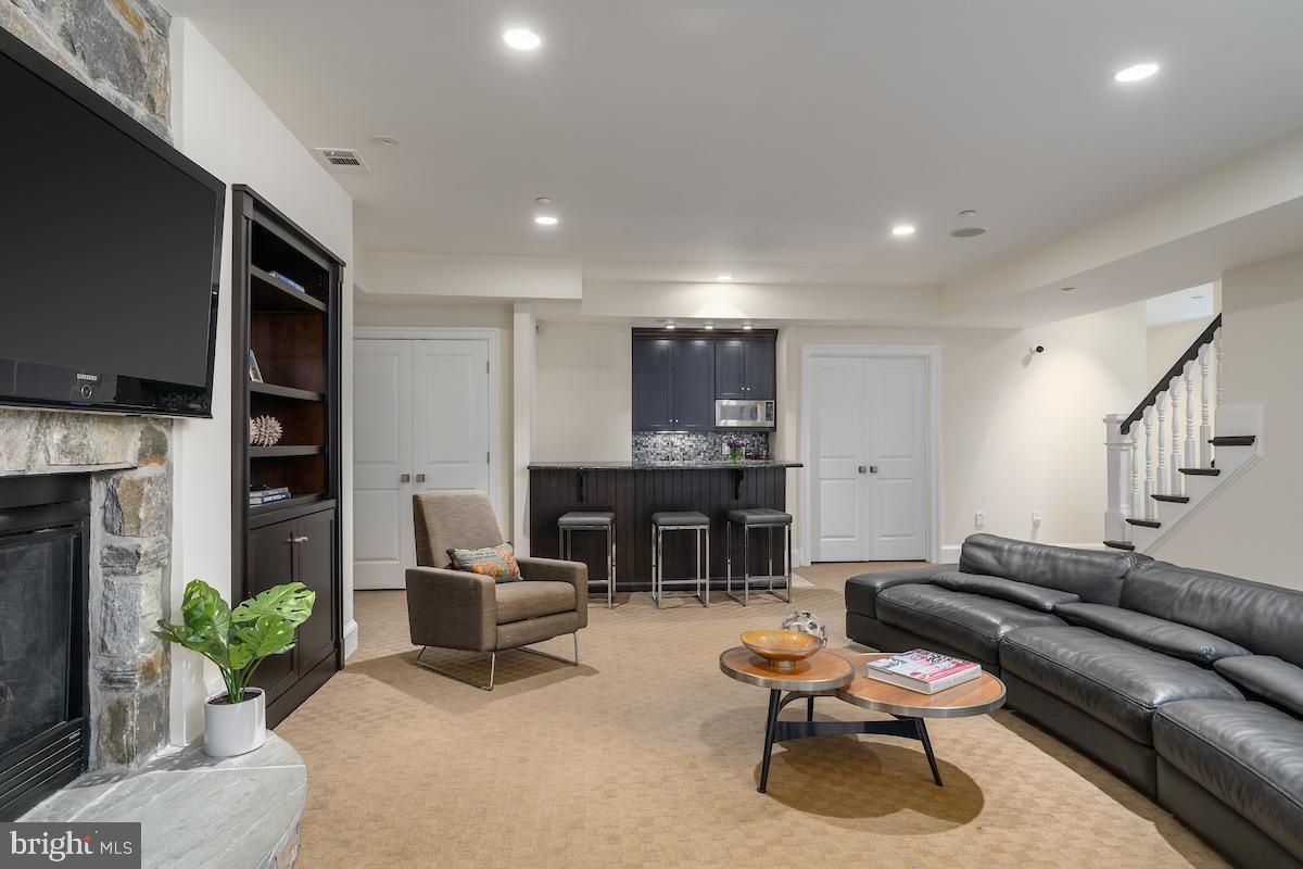 7803 Radnor Road Bethesda, MD 20817 - Photo 31 of 51 Lower level rec room with wet bar and fireplace